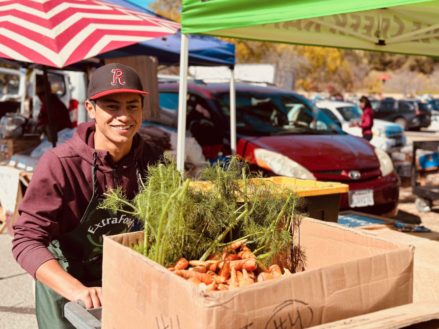 Young man with produce cart