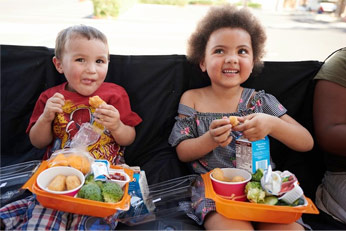 Kids smiling and eating